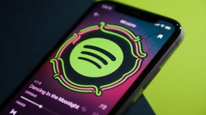 AI image of Spotify app on a smartphone / Spotify has launched new Offline Backup playlist feature.